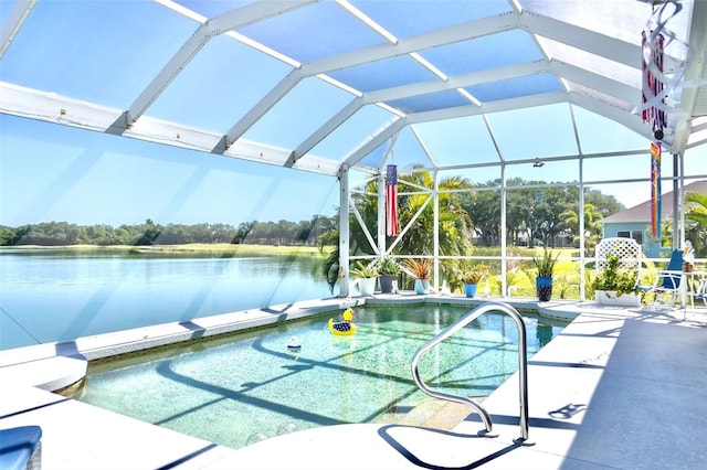 view of swimming pool featuring a lanai and a patio area