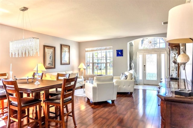 dining room featuring an inviting chandelier, hardwood / wood-style floors, and a wealth of natural light