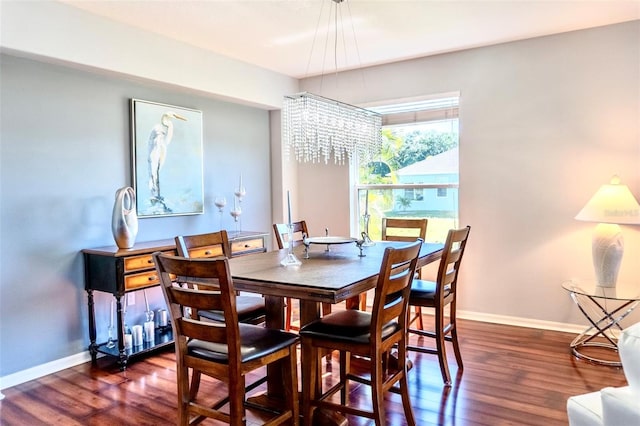 dining space featuring a notable chandelier and dark wood-type flooring