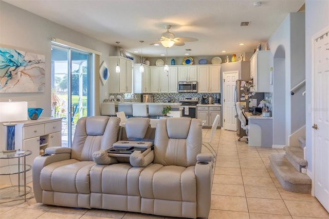 tiled living room featuring ceiling fan