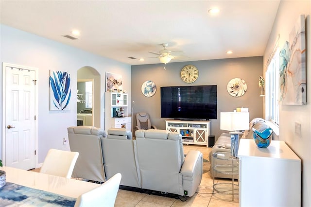 tiled living room featuring ceiling fan and washer / clothes dryer