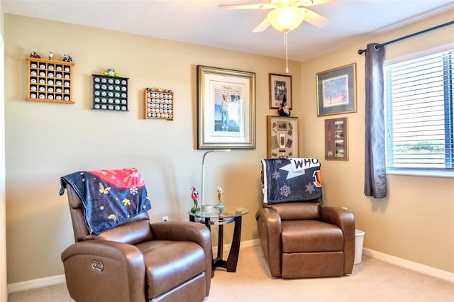 living area with carpet flooring and ceiling fan