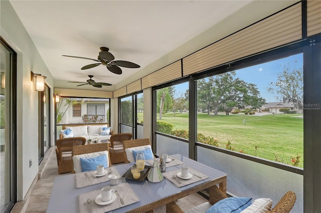 sunroom featuring ceiling fan