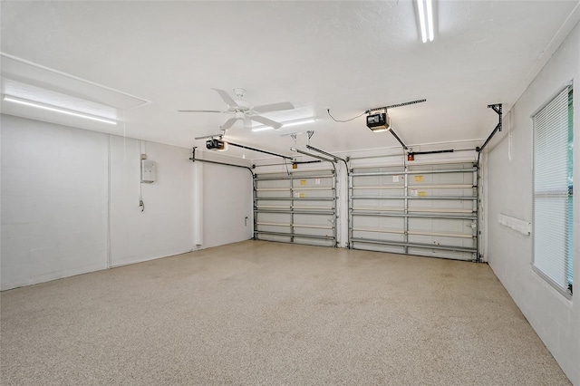 garage with ceiling fan and a garage door opener