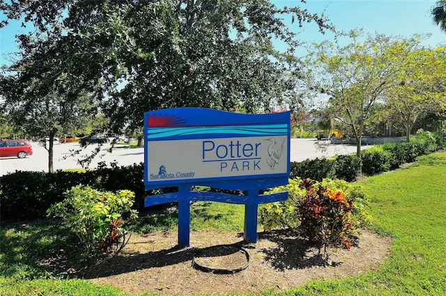 community sign featuring a lawn