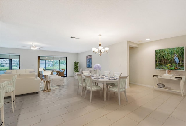 dining area with ceiling fan with notable chandelier and light tile patterned floors