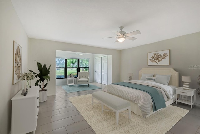 bedroom with tile flooring, ceiling fan, and a closet