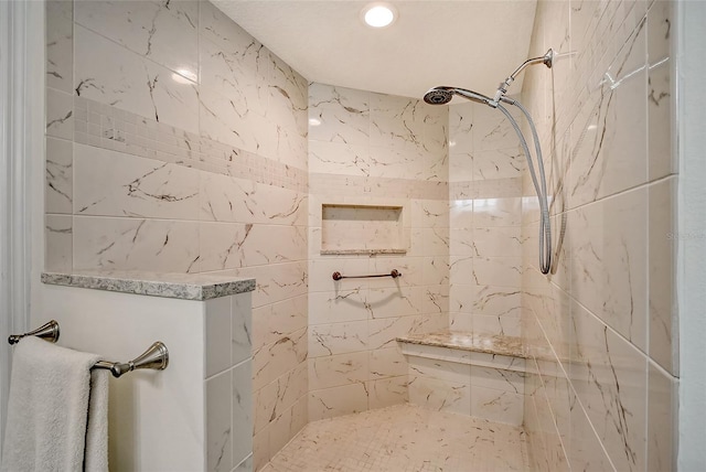 bathroom featuring tiled shower