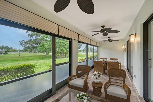 sunroom featuring ceiling fan