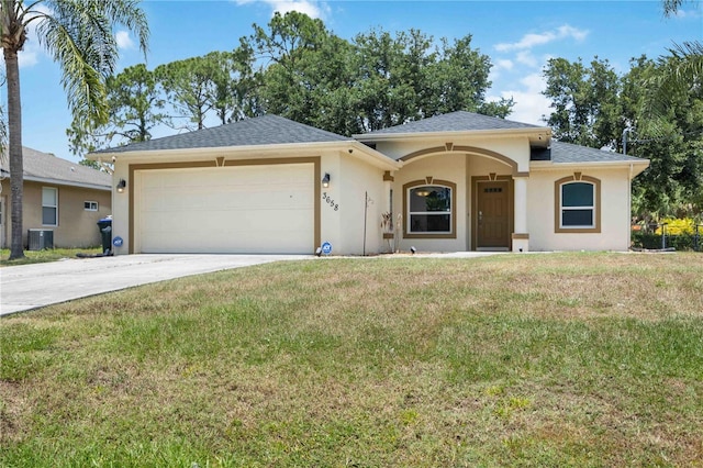 ranch-style house with a front yard, a garage, and central AC