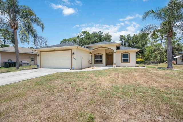 view of front of home featuring a garage and a front lawn