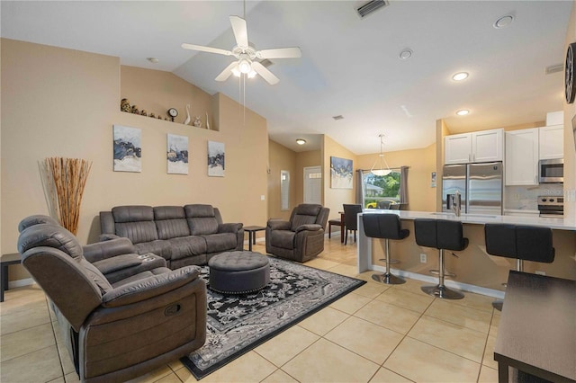 living room with vaulted ceiling, ceiling fan, and light tile flooring