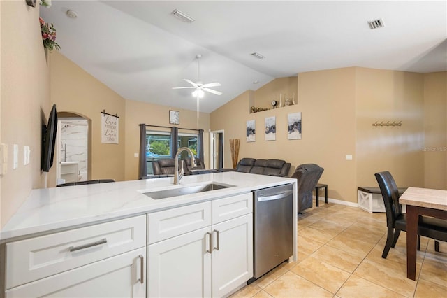 kitchen featuring ceiling fan, white cabinetry, stainless steel dishwasher, sink, and lofted ceiling