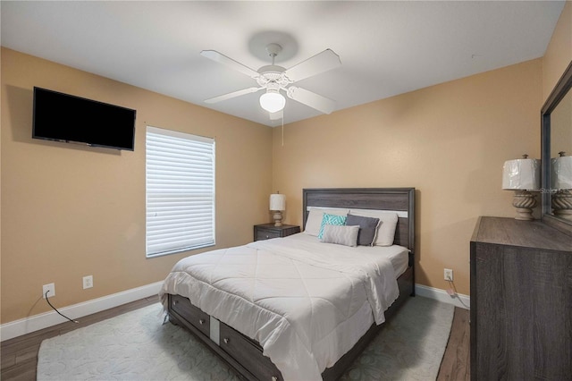 bedroom featuring hardwood / wood-style floors and ceiling fan