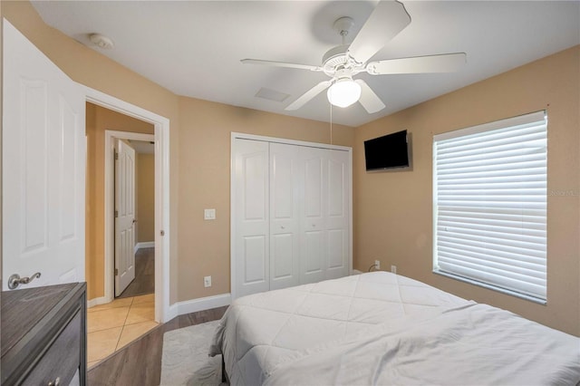 tiled bedroom with a closet and ceiling fan