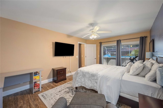 bedroom with ceiling fan and dark hardwood / wood-style flooring