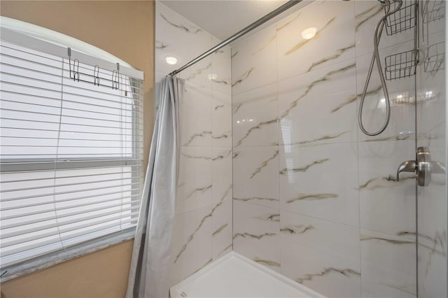 bathroom featuring walk in shower and plenty of natural light