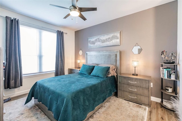 bedroom featuring light wood-type flooring and ceiling fan