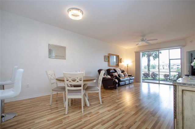 dining room with light hardwood / wood-style flooring and ceiling fan