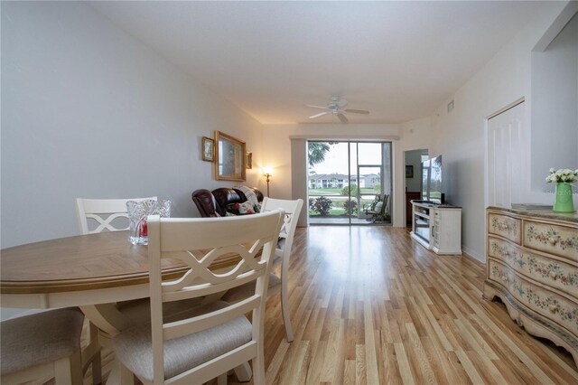 dining space with light hardwood / wood-style floors and ceiling fan