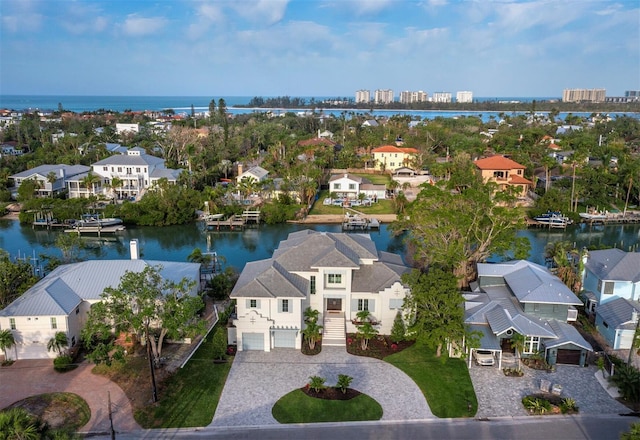 birds eye view of property with a water view and a residential view