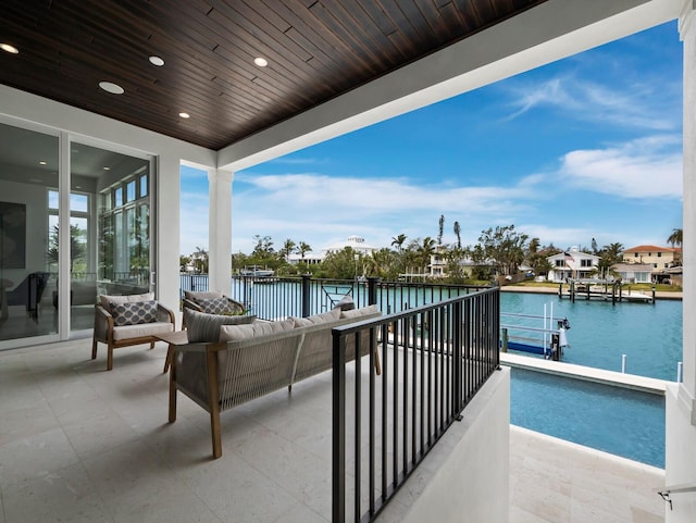 balcony with a water view and outdoor lounge area