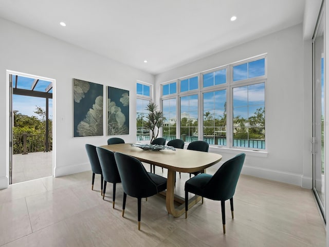 dining room with baseboards, plenty of natural light, and recessed lighting