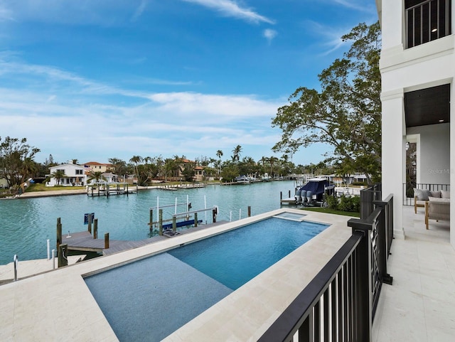 view of pool with a boat dock and a water view