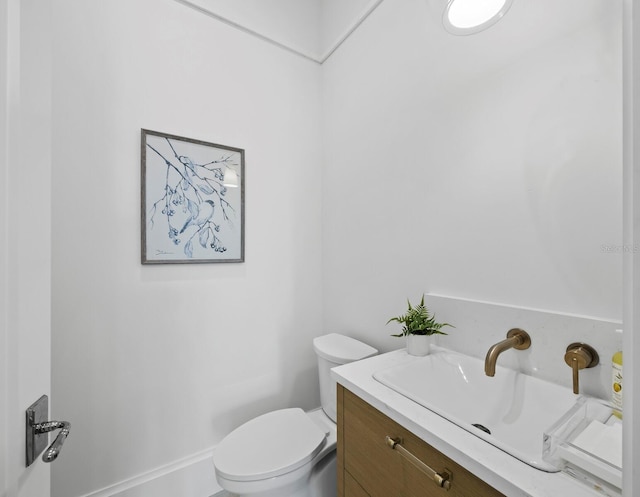bathroom with toilet and vanity