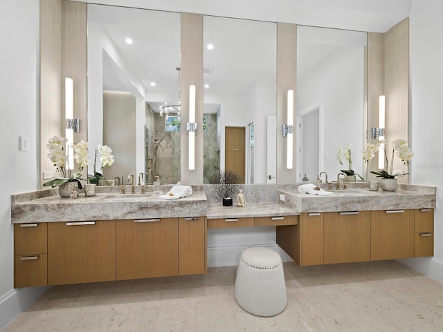 bathroom featuring a stall shower, two vanities, and recessed lighting