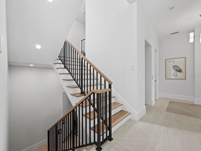 staircase with baseboards and recessed lighting