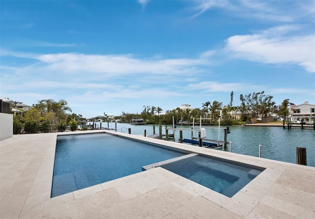 view of pool featuring a dock, a water view, a pool with connected hot tub, and boat lift