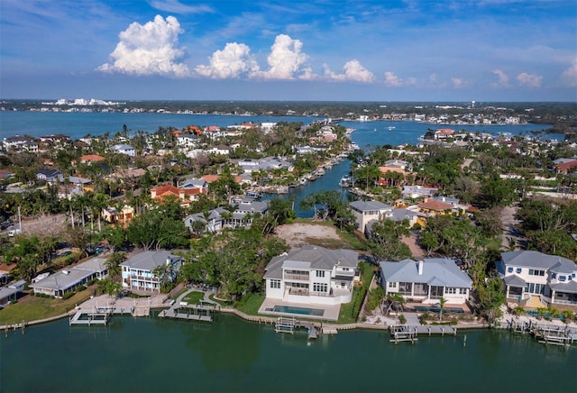 aerial view of property's location featuring nearby suburban area and a large body of water