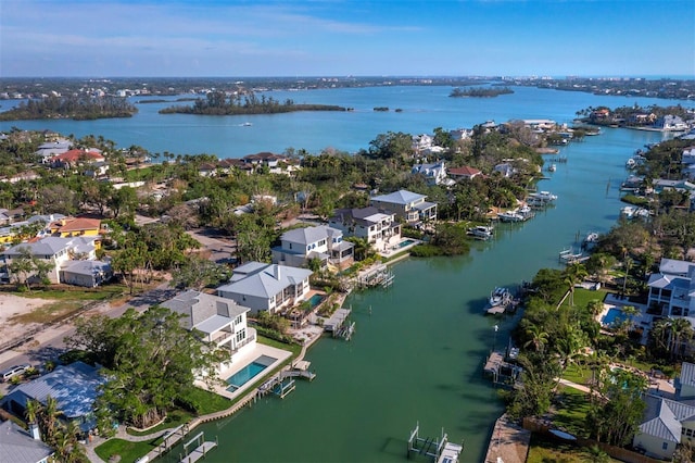 aerial perspective of suburban area with a nearby body of water