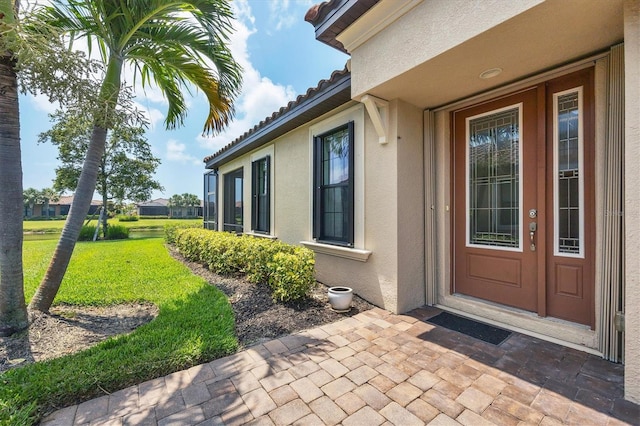 property entrance with a yard