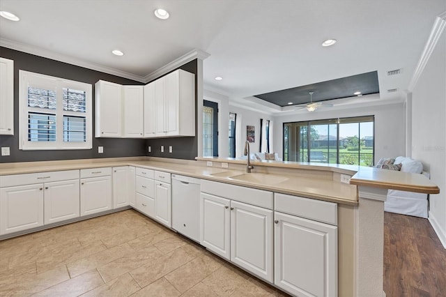 kitchen featuring ceiling fan, kitchen peninsula, dishwasher, sink, and ornamental molding