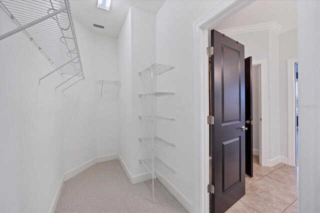 spacious closet featuring light tile floors