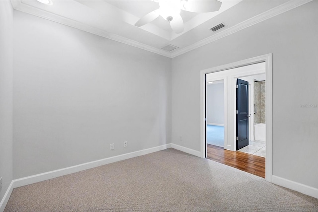 spare room featuring ceiling fan, light tile floors, and crown molding