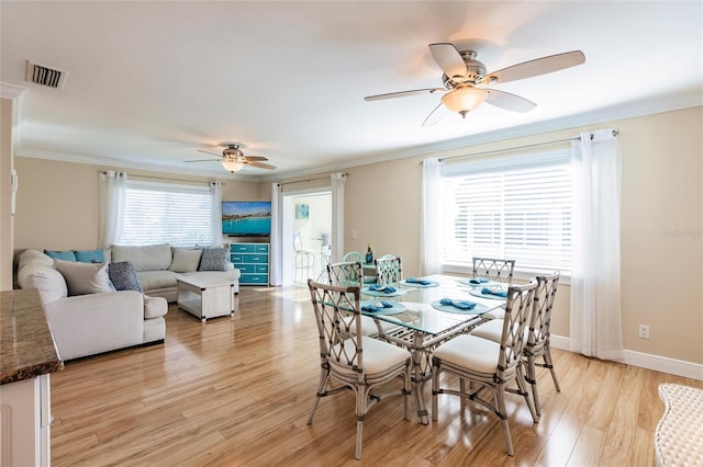 dining room with ceiling fan, light wood-type flooring, and ornamental molding