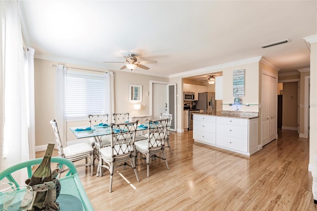 dining area featuring ornamental molding, ceiling fan, and light hardwood / wood-style flooring