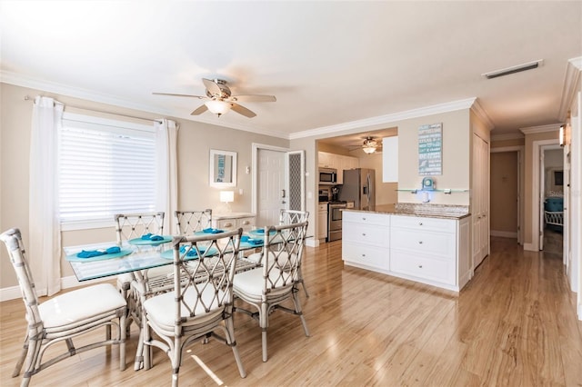 dining area featuring crown molding, ceiling fan, and light hardwood / wood-style flooring