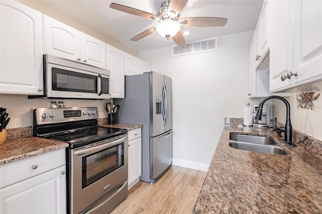 kitchen with ceiling fan, light hardwood / wood-style flooring, stainless steel appliances, sink, and white cabinetry