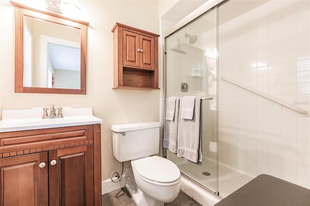 bathroom with an enclosed shower, toilet, and large vanity