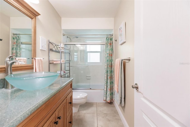 full bathroom with tile flooring, toilet, vanity, and tiled shower / bath