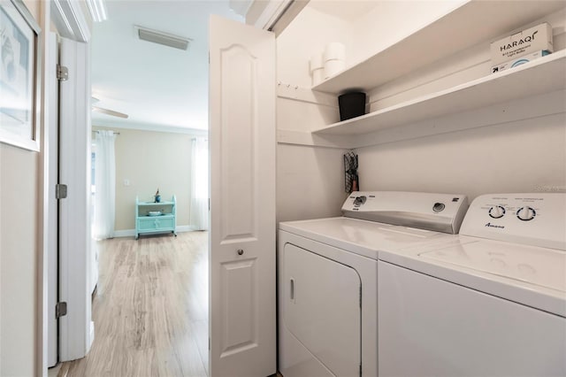 laundry room featuring washer and dryer and light wood-type flooring