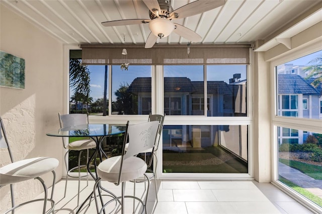 sunroom / solarium featuring ceiling fan