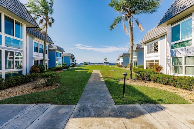 view of property's community featuring a yard