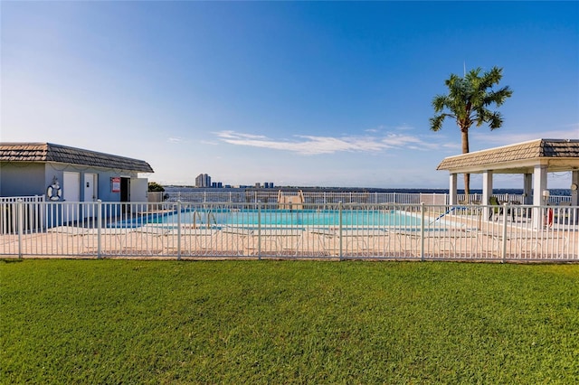 view of pool featuring a lawn