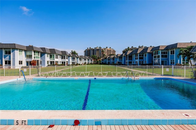 view of swimming pool featuring a lawn