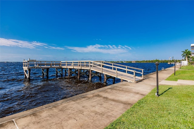 view of dock featuring a yard and a water view